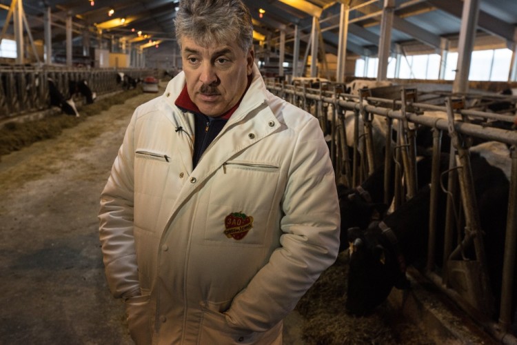 epa05778572 The director of the Lenin State Farm, Pavel Grudinin, speaks on robotic dairy farm on the CJSC 'Lenin State Farm' near Moscow, Russia, 08 February 2017. The robotic dairy farm was built using equipment and technology from the Netherlands company 'Lely'. Reports state that the farm consists of eight milking robots that caters for 1050 cows and the work is carried out with just three workers.  EPA/SERGEI ILNITSKY