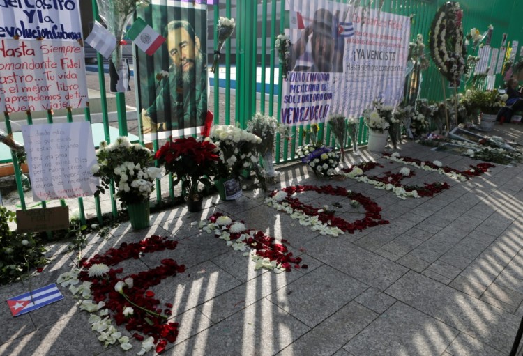 Pictures of Fidel Castro are seen beside his name made with flowers during a tribute ceremony, following the announcement of the death of the Cuban revolutionary leader, outside the Cuban Embassy in Mexico City, Mexico, November 27, 2016. REUTERS/Henry Romero
