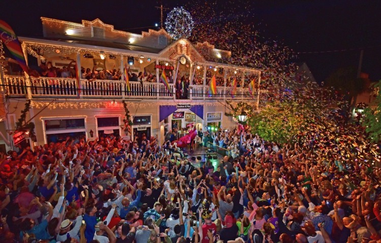 Revelers celebrate as female impersonator Gary Marion, known as "Sushi", is lowered during the Red Shoe Drop, at Duval Street in Key West, Florida, U.S., January 1, 2018. Rob O'Neal/Florida Keys News Bureau/Handout via REUTERS   ATTENTION EDITORS - THIS IMAGE WAS PROVIDED BY A THIRD PARTY. NO RESALES. NO ARCHIVES.
