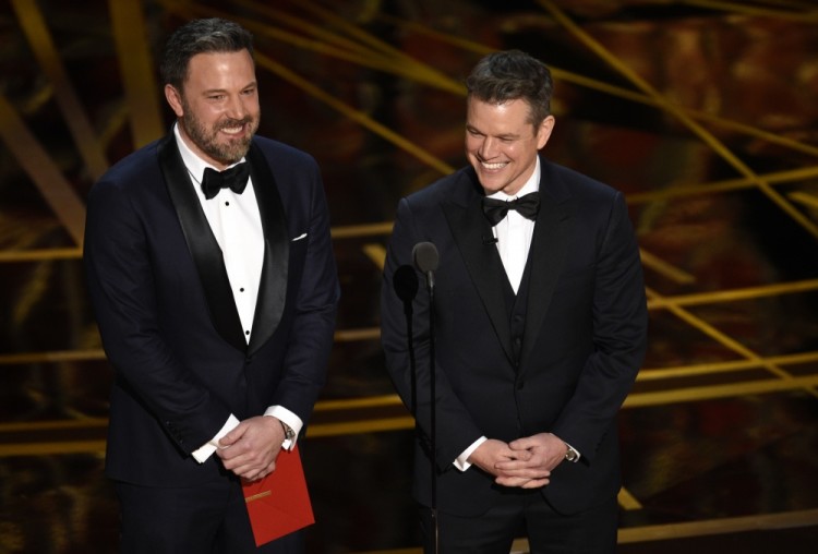 Ben Affleck, left, and Matt Damon present the award for best original screenplay at the Oscars on Sunday, Feb. 26, 2017, at the Dolby Theatre in Los Angeles. (Photo by Chris Pizzello/Invision/AP)
