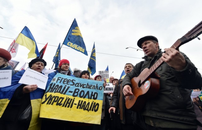 Protesters shout slogan "Free Savchenko!" and hold portraits of jailed female Ukrainian pilot Nadiya Savchenko during a rally in front of Russian embassy in Kiev on March 9, 2016. Ukraine on March 9, 2016 demanded that Moscow "immediately" free Nadiya Savchenko, a hunger-striking military helicopter pilot on trial in Russia. / AFP / SERGEI SUPINSKY