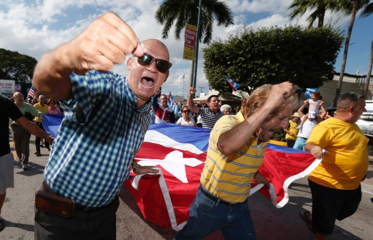 Cuban Americans celebrate the death of Cuban leader Fidel Castro on the streets in the Little Havana neighborhood of Miami Florida on November 27, 2016. / AFP PHOTO / RHONA WISE