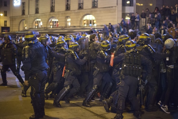 Anti riot police officers push a group of demonstrators during scufflings in Paris, Sunday, April 23, 2017. Protesters angry that far-right leader Marine Le Pen is advancing the French presidential runoff are scuffling with police in Paris. Crowds of young people, some from anarchist and "anti-fascist" groups, gathered on the Place de la Bastille in eastern Paris as results were coming in from Sunday's first-round vote. (AP Photo/Emilio Morenatti)