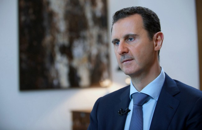 In this photo released by the Syrian official news agency SANA, shows Syrian President Bashar Assad, speaking during an interview with the Iran's Khabar TV, in Damascus, Syria, Sunday, Oct. 4, 2015. Assad said in the interview aired Sunday the air campaign by Russia against "terrorists" in his country must succeed or the whole region will be destroyed. He also accused Western nations of fueling the refugee crisis. (SANA via AP)