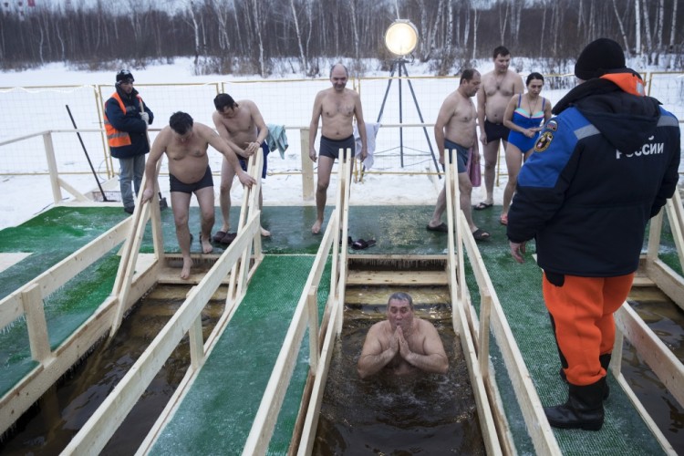 A Russian Orthodox believers come to bath in the icy water on Epiphany at a pond in Moscow, Thursday, Jan. 19, 2017. Thousands of Russian Orthodox Church followers will plunge into icy rivers and ponds across the country to mark Epiphany, cleansing themselves with water deemed holy for the day. (AP Photo/Pavel Golovkin)