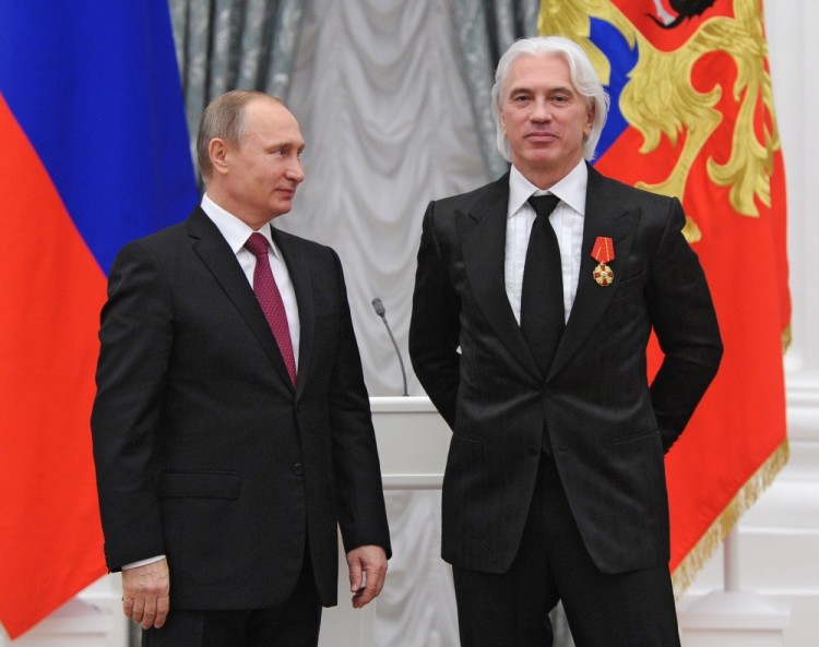 FILE - In this Dec. 10, 2015, file photo, Russian President Vladimir Putin, left, gives a state medal to world-renowned Russian baritone opera singer Dmitry Khvorostovsky during the award ceremony in the Kremlin in Moscow, Russia  Hvorostovsky died after a long battle with cancer. He was 55. Hvorostovsky's office said in a statement Wednesday, Nov. 22, 2017, that the acclaimed singer "died peacefully" earlier and was "surrounded by family" near his home in London. (Mikhail Klimentyev/Sputnik, Kremlin Pool Photo via AP, File)