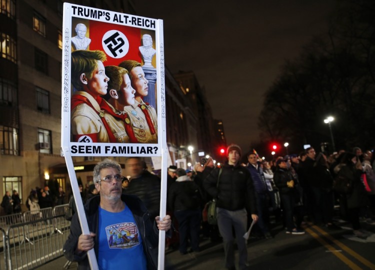 A protester holds a sign making a play on words about the alt-Right movement at an anti-Trump rally and protest in front of the Trump International Hotel, Thursday, Jan. 19, 2017, in New York. President-elect Donald Trump, a New Yorker, is scheduled to take the oath of office Friday at his own inauguration in Washington. (AP Photo/Kathy Willens)