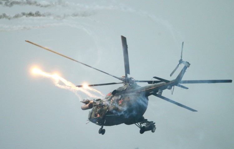 epa06210270 A Belarussian Mi-8 helicopter fires during a joint Russian-Belarusian military drill 'Zapad 2017' near the town of Ruzhany, some 235 km from Minsk, Belarus, 17 September 2017. Recent media reports stated that the strategic 'Zapad 2017' military maneuvers of the armed forces of the Russian Federation and Belarus are taking place from 14 to 20 September in Belarus and three military training grounds in Russia.  EPA/TATYANA ZENKOVICH