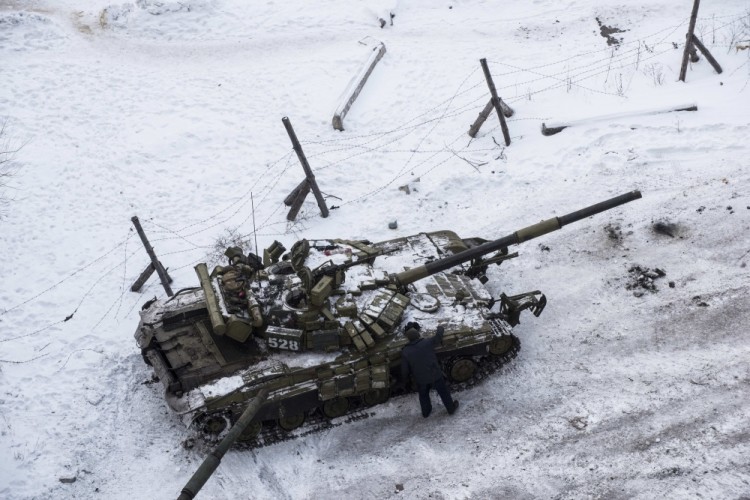 A Ukrainian tank stands in the yard of an apartment block in Avdiivka, eastern Ukraine, Wednesday, Feb. 1, 2017. Heavy fighting around government-held Avdiivka, just north of the rebel-stronghold city of Donetsk, began over the weekend and persisted into early Wednesday. The Contact Group called for the opposing sides to cease fire and urged them to pull back their heavy weapons by the end of the week. (AP Photo/Evgeniy Maloletka)