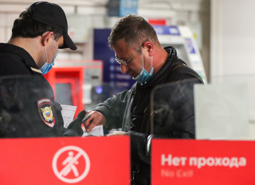 Полицейский проверяет пропуск у мужчины в метро. Фото: Vladimir Gerdo / TASS / Scanpix / Leta