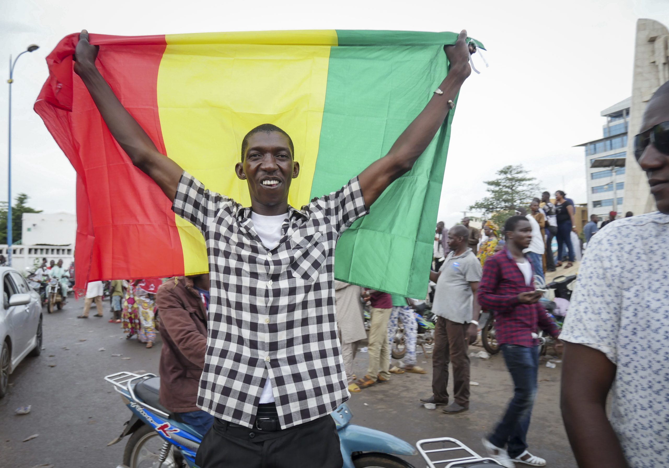 Мужчина держит национальный флаг на улице Бамако в Мали. 18 августа 2020 г. Фото TASS / Scanpix / Leta