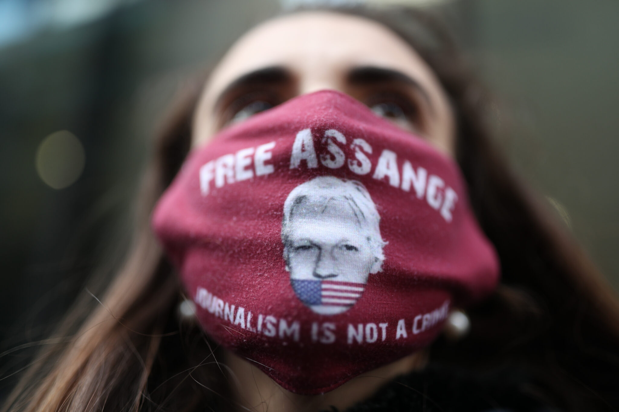 Маска участницы акции протеста против экстрадиции Ассанжа с его изображением и надписью "Освободите Ассанжа, журналистика – не преступление". Фото PA Wire/PA Images/Scanpix/Leta