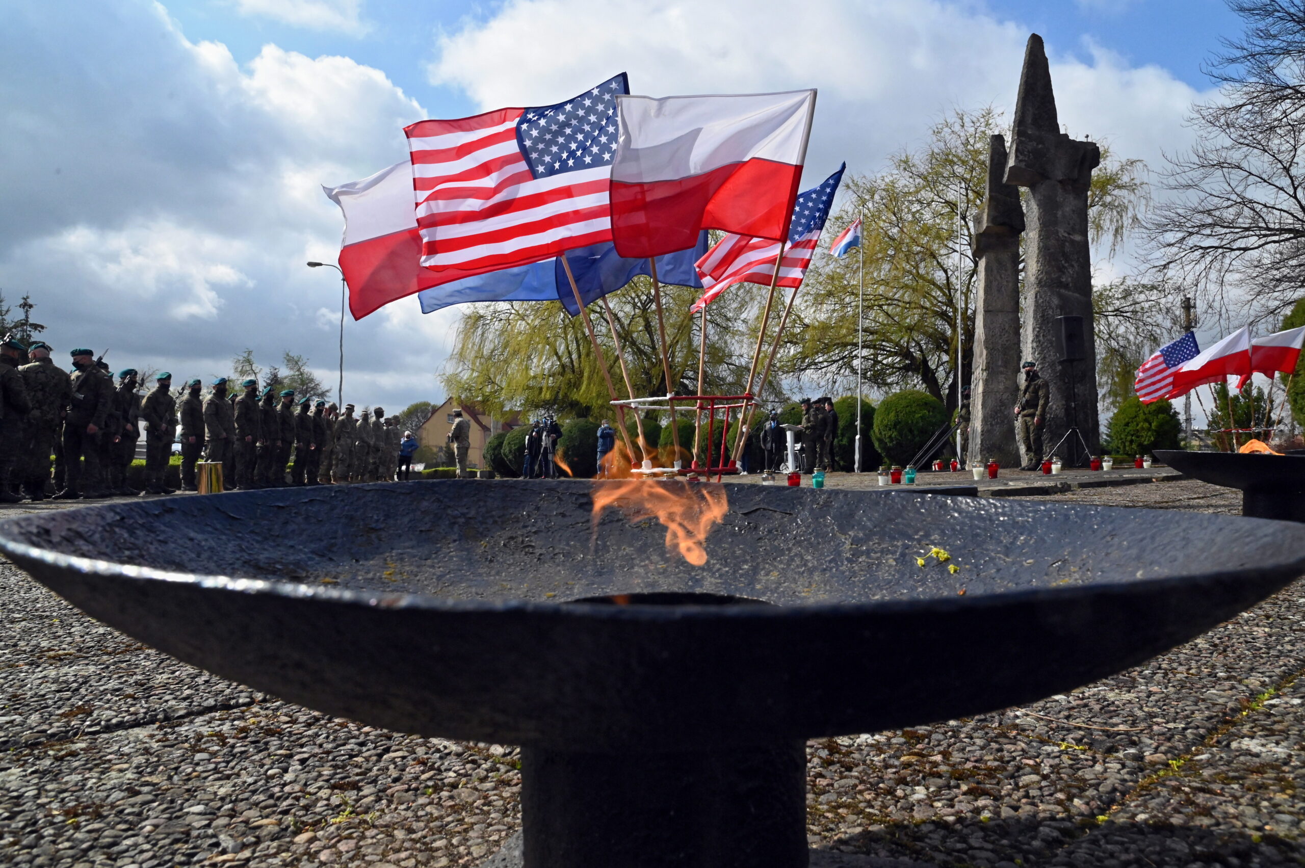 Флаги США, Польши и других союзников на военном кладбище и вечный огонь. Фото  EPA/Marcin Bielecki /Scanpix/Leta