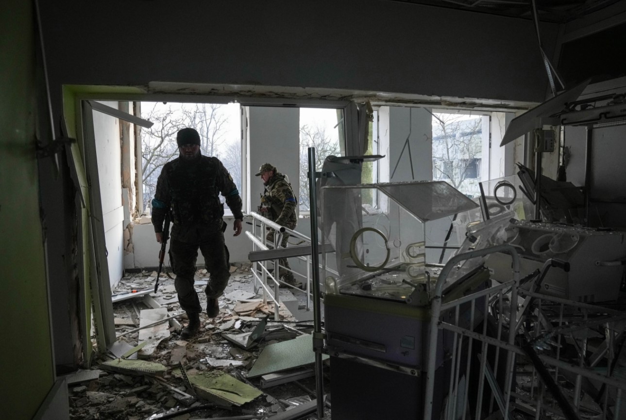 Украинские военные на территории пострадавшего в результате обстрела родильного дома в Мариуполе, Украина, 9 марта 2022 года. Фото Evgeniy Maloletka/AP Photo/Scanpix/Leta