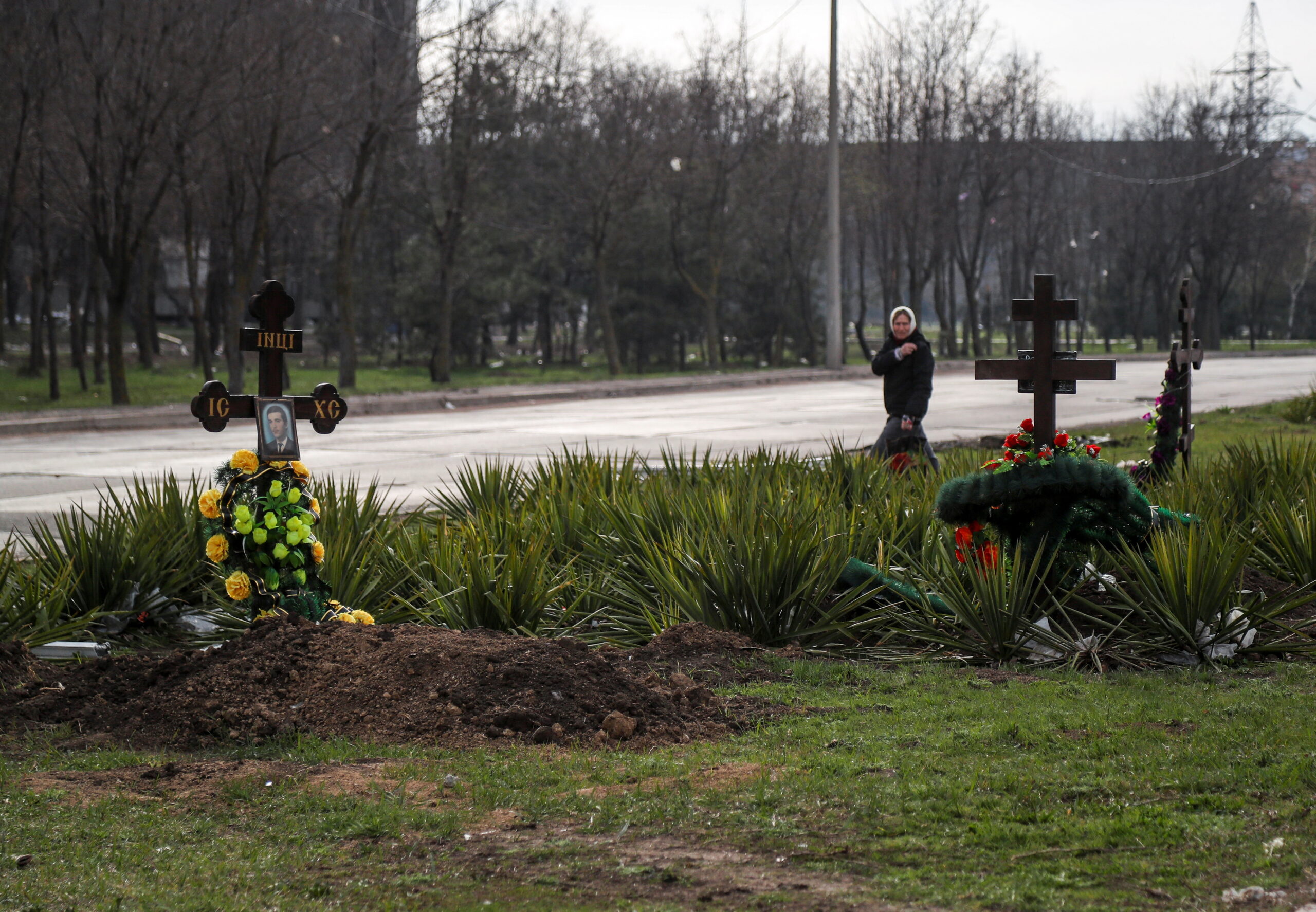 Женщина рядом с могилами убитых мирных жителей в Мариуполе. 10 апреля 2022 года. Фото REUTERS/Alexander Ermochenko/Scanpix/LETA