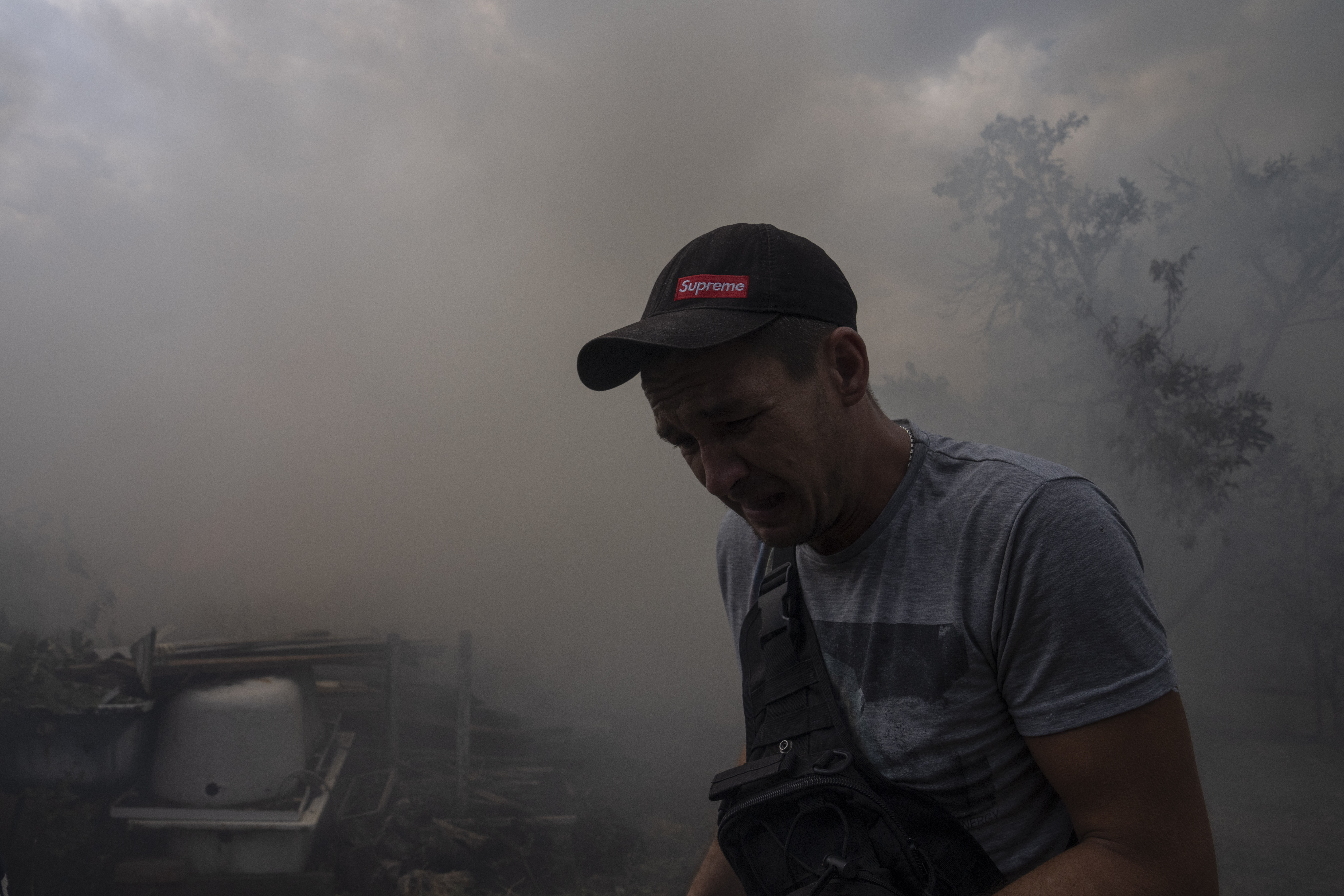 Мужчина на фоне горящего дома после обстрела. Константиновка. 9 июля 2022 года. Фото AP Photo/Nariman El-Mofty/Scanpix/LETA