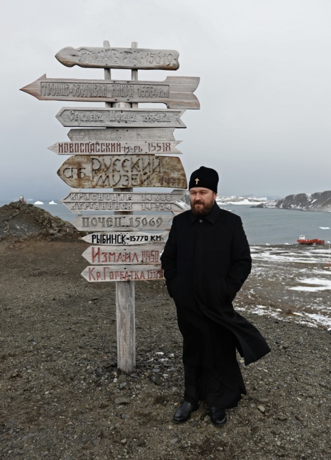 2793176 02/17/2016 Metropolitan Ilarion stands by a memorial direction post near the Trinity Church on King George island in Antarctica. Patriarch of Moscow and All Russia Kirill paid a visit to the Russian Bellingshausen polar station on the island. Sergey Pyatakov/Sputnik