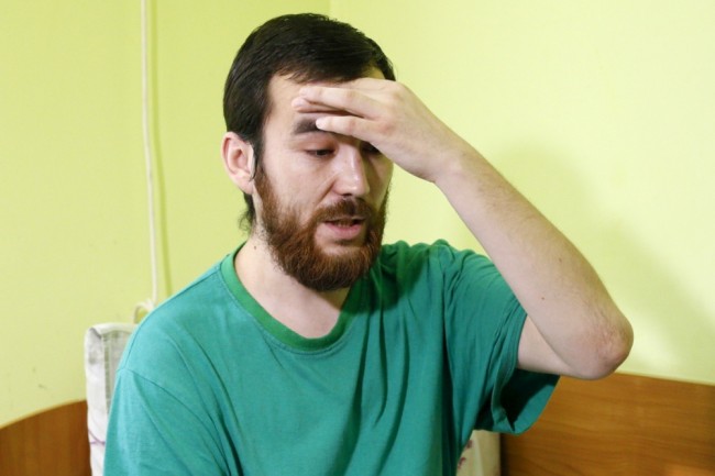 A man, who according to Ukraine's state security service (SBU) is named Yevgeny Yerofeyev and is one of two Russian servicemen detained on May 17 by Ukrainian forces, answers reporter's questions at a hospital in Kiev, Ukraine, July 28, 2015. Commenting on information from a number of media outlets, SBU denied on Tuesday that two Russian citizens Yevgeny Yerofeyev and Alexander Alexandrov were exchanged for Ukrainian servicemen, local media reported. REUTERS/Valentyn Ogirenko