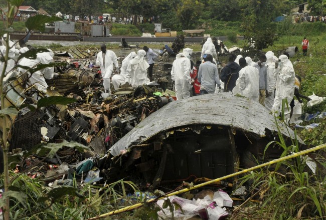 ATTENTION EDITORS - VISUALS COVERAGE OF SCENES OF DEATH OR INJURY Officials investigate the wreckage of a cargo airplane that crashed after take-off near Juba Airport in South Sudan November 4, 2015. A Russian-built cargo plane carrying some passengers crashed on Wednesday after taking off from the airport in South Sudan's capital, killing at least 41 people who were on board and others on the ground, an official and a Reuters witness said. REUTERS/Jok Solomun  TEMPLATE OUT.