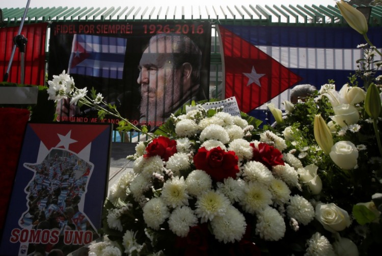 Cuban flags, pictures of Fidel Castro and flowers are seen during a tribute ceremony outside the Cuban Embassy in Mexico City, Mexico November 27, 2016. REUTERS/Henry Romero