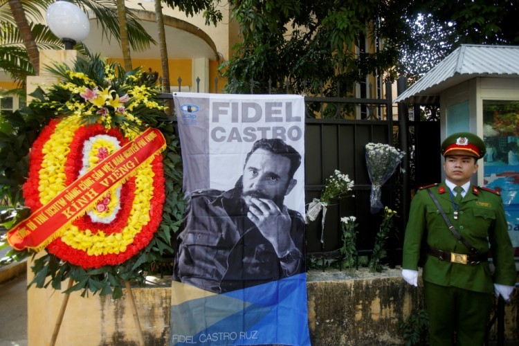 Vietnamese guard stands outside Cuban embassy while as people pay tribute to late leader Fidel Castro in Hanoi November 28, 2016. REUTERS/Kham
