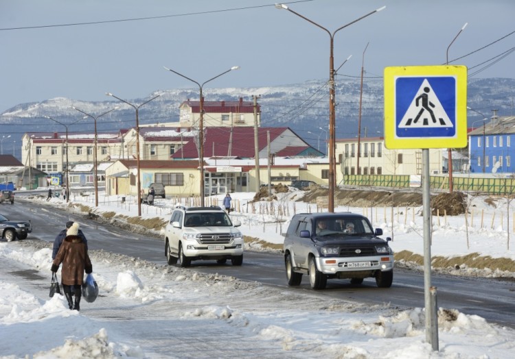 Cars drive on a street in the settlement of Yuzhno-Kurilsk on the Island of Kunashir, one of four islands known as the Southern Kuriles in Russia and the Northern Territories in Japan, December 21, 2016. REUTERS/Yuri Maltsev