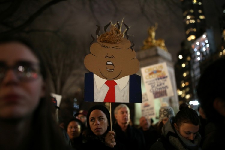 People rally against U.S. president-elect Donald Trump outside Trump International Hotel and Tower at Columbus Circle in Manhattan, New York City, U.S., January 19, 2017. REUTERS/Stephen Yang