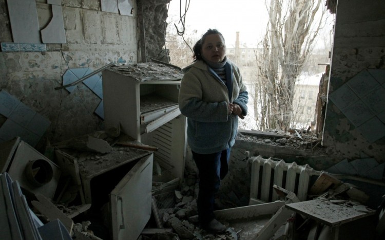 A woman stands amidst the debris of her damaged apartment, which according to locals was caused by recent shelling, in Donetsk, Ukraine, February 1, 2017. REUTERS/Alexander Ermochenko