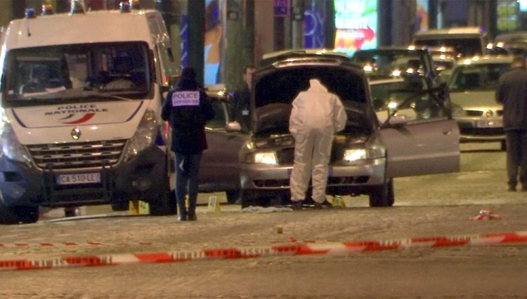 REFILE - CORRECTING CASUALTY NUMBER  A still image from video footage shows Police investigators inspect the car used by the attacker on the Champs Elysees Avenue after a policeman was killed and two others were wounded in a shooting incident in Paris, France, April 20, 2017.    REUTERS/Reuters Tv