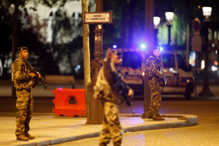 REFILE - CORRECTING CASUALTY NUMBER  Armed soldiers secure the Champs Elysees Avenue after a policeman was killed and two others were wounded in a shooting incident in Paris, France, April 20, 2017. REUTERS/Benoit Tessier