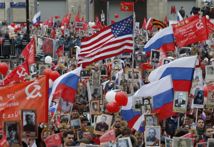People carry flags and pictures of World War Two soldiers as they take part in the Immortal Regiment march during the Victory Day celebrations, marking the 72nd anniversary of the victory over Nazi Germany in World War Two, in central Moscow, Russia, May 9, 2017. REUTERS/Sergei Karpukhin