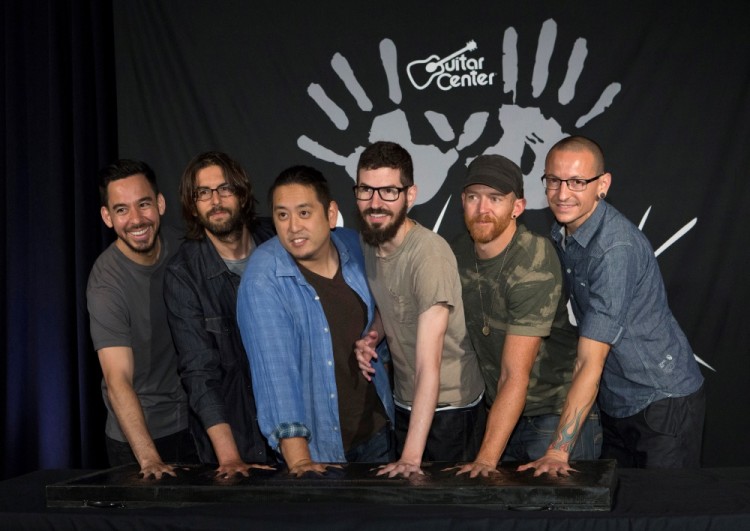 FILE PHOTO: Members of rock band Linkin Park (L-R) Mike Shinoda, Rob Bourdon, Joe Hahn, Brad Delson, Dave Farrell and Chester Bennington put their handprints in cement as they are inducted into Guitar Center's RockWalk in Los Angeles, California June 18, 2014. REUTERS/Mario Anzuoni/File Photo