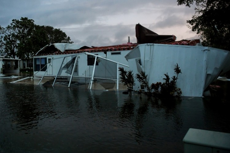 Flood water from Hurricane Irma surround a damaged mobile home in Bonita Springs, Florida, U.S., September 10, 2017. REUTERS/Bryan Woolston
