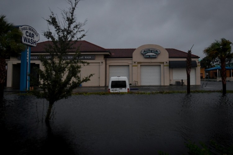Floodwater from Hurricane Irma surrounds a car wash in Bonita Springs, Florida, U.S., September 10, 2017. REUTERS/Bryan Woolston