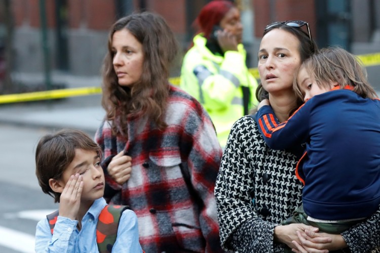 Parents arrive to pick up children outside P.S./I.S.-89 school, after a man driving a rented pickup truck mowed down pedestrians and cyclists on a bike path alongside the Hudson River in New York City on Tuesday, in New York, U.S. October 31, 2017. REUTERS/Shannon Stapleton