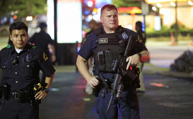 DALLAS, TX - JULY 7: Dallas police stand near the scene where four Dallas police officers were shot and killed on July 7, 2016 in Dallas, Texas. According to reports, shots were fired during a protest being held in downtown Dallas in response to recent fatal shootings of two black men by police - Alton Sterling on July 5, 2016 in Baton Rouge, Louisiana and Philando Castile on July 6, 2016, in Falcon Heights, Minnesota.   Ron Jenkins/Getty Images/AFP == FOR NEWSPAPERS, INTERNET, TELCOS & TELEVISION USE ONLY ==