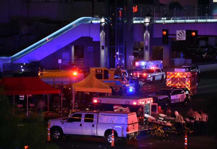 LAS VEGAS, NV - OCTOBER 02: Police and rescue personnel gather at the intersection of Las Vegas Boulevard and Tropicana Ave. after a mass shooting at a country music festival nearby on October 2, 2017 in Las Vegas, Nevada. A gunman has opened fire on a music festival in Las Vegas, leaving at least 2 people dead. Police have confirmed that one suspect has been shot. The investigation is ongoing.   Ethan Miller/Getty Images/AFP == FOR NEWSPAPERS, INTERNET, TELCOS & TELEVISION USE ONLY ==