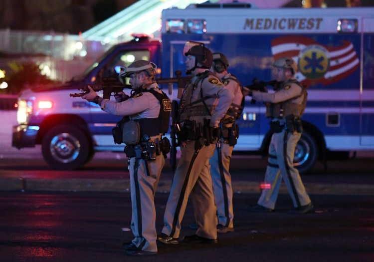 LAS VEGAS, NV - OCTOBER 02: Police officers point their weapons at a car driving down closed Tropicana Ave. near Las Vegas Boulevard after a reported mass shooting at a country music festival nearby on October 2, 2017 in Las Vegas, Nevada. A gunman has opened fire on a music festival in Las Vegas, leaving at least 2 people dead. Police have confirmed that one suspect has been shot. The investigation is ongoing.   Ethan Miller/Getty Images/AFP == FOR NEWSPAPERS, INTERNET, TELCOS & TELEVISION USE ONLY ==