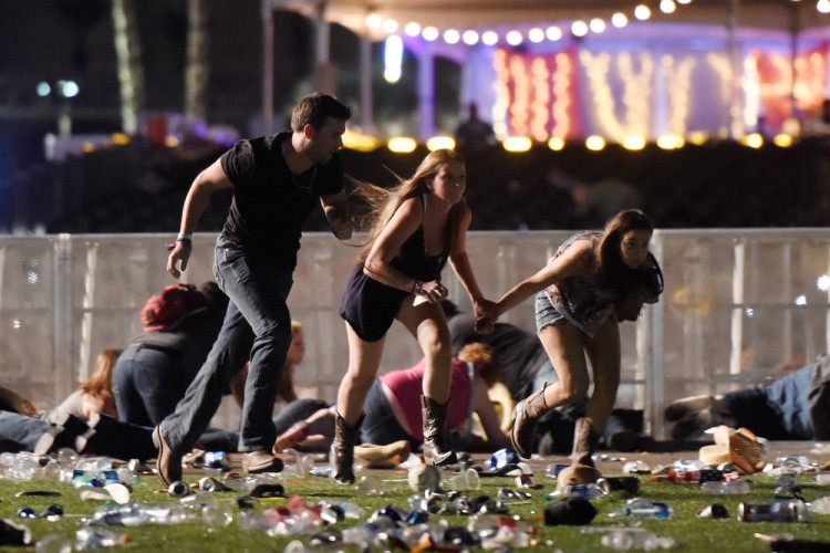 LAS VEGAS, NV - OCTOBER 01: People run from the Route 91 Harvest country music festival after apparent gun fire was hear on October 1, 2017 in Las Vegas, Nevada. A gunman has opened fire on a music festival in Las Vegas, leaving at least 20 people dead and more than 100 injured. Police have confirmed that one suspect has been shot. The investigation is ongoing.   David Becker/Getty Images/AFP == FOR NEWSPAPERS, INTERNET, TELCOS & TELEVISION USE ONLY ==