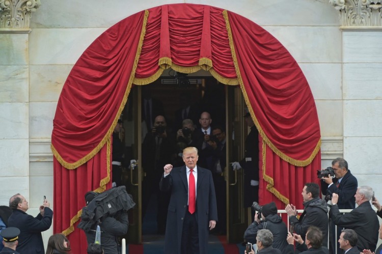 President-elect Donald Trump acknowledges guests as he arrives on the platform at the US Capitol in Washington, DC, on January 20, 2017, during his swearing-in ceremony. / AFP PHOTO / Mandel NGAN
