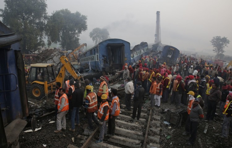 Rescuers work at the site after 14 coaches of an overnight passenger train rolled off the track near Pukhrayan village in Kanpur Dehat district of the northern Indian state of Uttar Pradesh, India, Monday, Nov. 21, 2016. Dozens died and dozens more were injured in the accident. (AP Photo/Rajesh Kumar Singh)