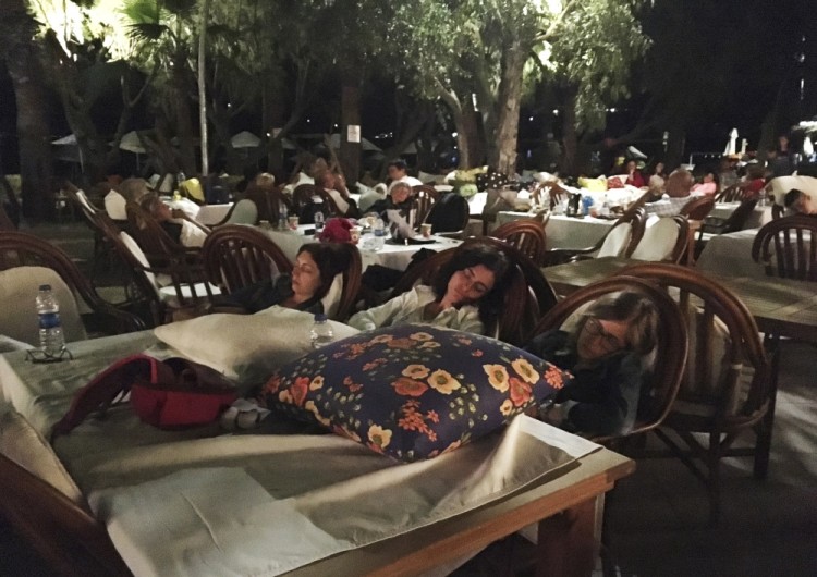 Hotel guests sleep outdoors after abandoning their rooms following an earthquake in Bitez, a resort town about 6 kilometers (4 miles) west of Bodrum, Turkey, early Friday, July 21, 2017. A powerful earthquake struck Turkey's Aegean coast and nearby Greek islands, sending frightened residents running out of buildings they feared would collapse and into the streets. (AP Photo/Ayse Wieting)