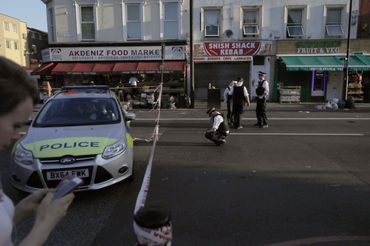 Police officers work at a cordoned area near Finsbury Park station after a vehicle struck pedestrians in north London, Monday, June 19, 2017. A vehicle struck pedestrians near a mosque in north London early Monday morning. (AP Photo/Tim Ireland)