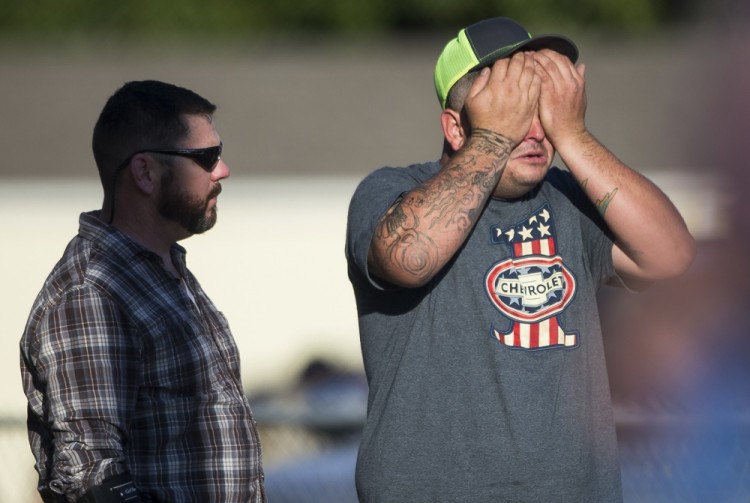 A man wipes his eyes after a deadly shooting at the First Baptist Church in Sutherland Springs, Texas, Sunday, Nov. 5, 2017. A man opened fire inside of the church in the small South Texas community on Sunday, killing more than 20 people. (Nick Wagner/Austin American-Statesman via AP)