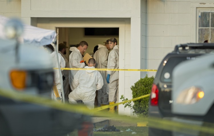 Investigators work at the scene of a deadly shooting at the First Baptist Church in Sutherland Springs, Texas, Sunday Nov. 5, 2017. A man opened fire inside of the church in the small South Texas community on Sunday, killing more than 20 people. (Jay Janner/Austin American-Statesman via AP)