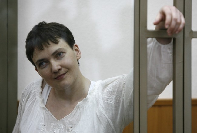Ukrainian airforce helicopter navigator Nadezhda (Nadya) Savchenko, charged with involvement in the killing of two Russian journalists in war-torn eastern Ukraine, looks out from a defendants' cage during a hearing at a court in the southern Russian town of Donetsk, Rostov region, on September 29, 2015. AFP PHOTO / SERGEI VENYAVSKY