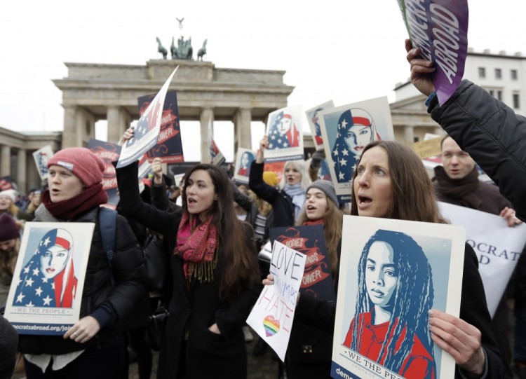 Protesters attend a 'Berlin Women's March on Washington' demonstration in front of the Brandenburg Gate in Berlin, Germany, Saturday, Jan. 21, 2017, the day after the inauguration of Donald Trump as new President of the United States. (AP Photo/Michael Sohn)