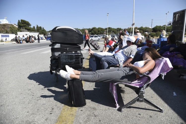 Passengers gather outside the airport after the cancelation of many flights on the Greek island of Kos on Friday, July 21, 2017. A powerful earthquake sent a building crashing down on tourists at a bar on the Greek holiday island of Kos and struck panic on the nearby shores of Turkey early Friday, killing two people and injuring some 200 people. (Nikos Christofakis/InTime News via AP)