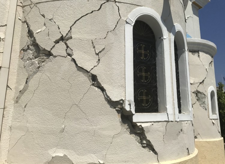 A crack sits in the facade of a church after an earthquake in Kos on the island of Kos, Greece Friday, July 21, 2017. Greek authorities said two tourists killed in the overnight quake are from Turkey and Sweden.(AP Photo/Michael Probst)