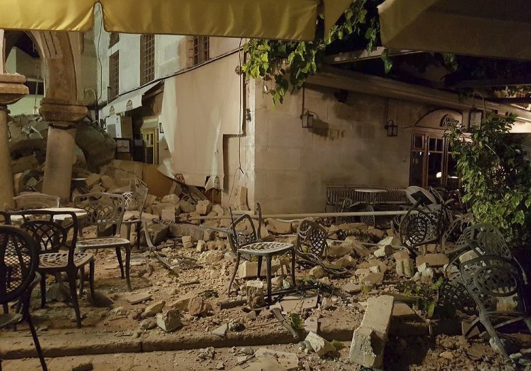 A cafe setting is littered with rubble following a strong earthquake on the Greek island of Kos early Friday, July 21, 2017. A powerful earthquake struck Turkey's Aegean coast and nearby Greek islands, sending frightened residents running out of buildings they feared would collapse and into the streets. (Sander van Deventer via AP)